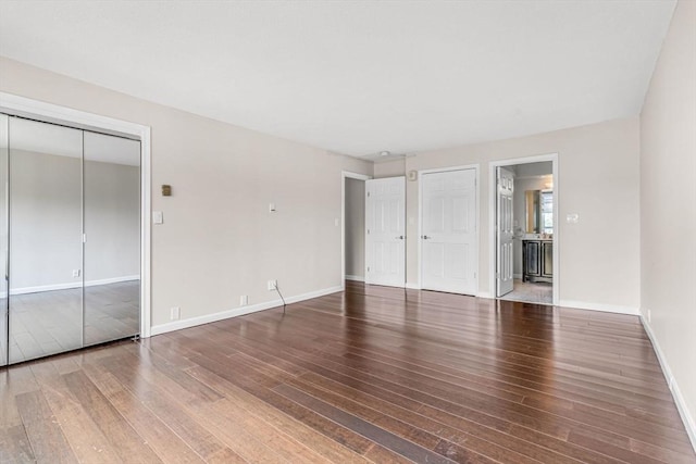 280 Boylston St Unit 511, Newton, MA 02467 - unfurnished bedroom with hardwood / wood-style flooring and baseboards