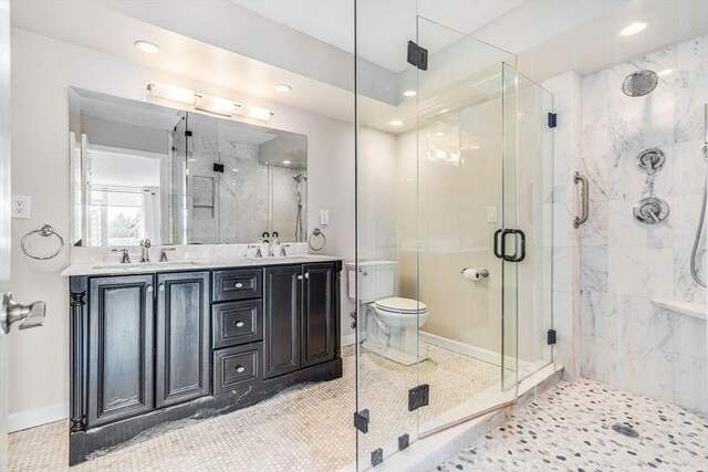 280 Boylston St Unit 511, Newton, MA 02467 - bathroom featuring a marble finish shower, double vanity, toilet, recessed lighting, and baseboards