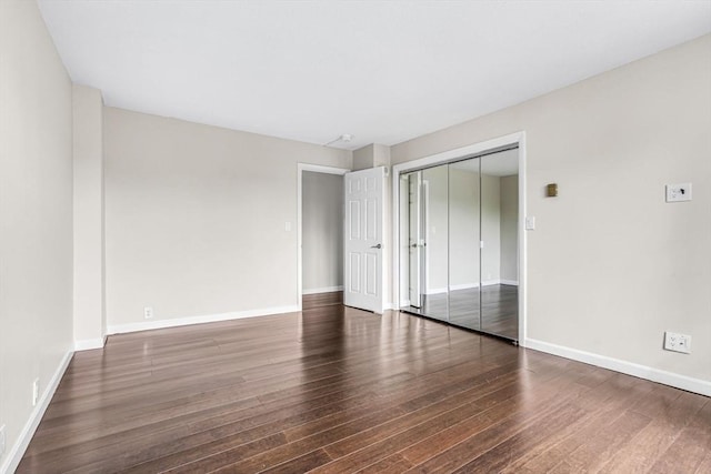 280 Boylston St Unit 511, Newton, MA 02467 - unfurnished bedroom with wood finished floors, baseboards, and a closet