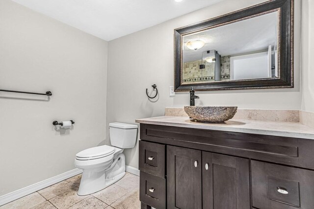 280 Boylston St Unit 511, Newton, MA 02467 - bathroom with baseboards, vanity, toilet, and tile patterned flooring