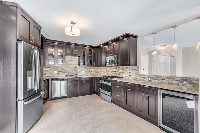 280 Boylston St Unit 511, Newton, MA 02467 - kitchen with appliances with stainless steel finishes, wine cooler, tasteful backsplash, and dark brown cabinets