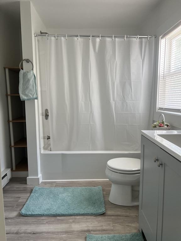 26A Duval Ct, Winchendon, MA 01475 - bathroom featuring shower / tub combo, baseboard heating, toilet, and wood finished floors