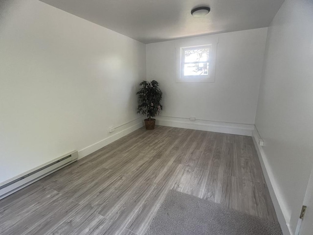 26A Duval Ct, Winchendon, MA 01475 - spare room featuring a baseboard heating unit, wood finished floors, and baseboards