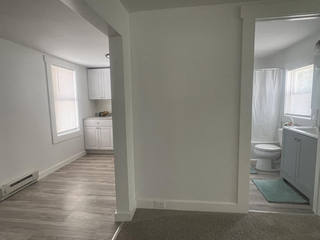 26A Duval Ct, Winchendon, MA 01475 - corridor featuring a baseboard radiator, baseboards, and light wood-style floors