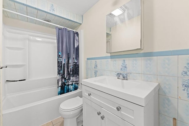 full bathroom featuring vanity, shower / bath combo with shower curtain, tile walls, tile patterned flooring, and toilet