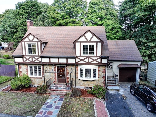 tudor house featuring a garage