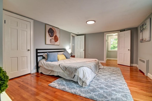 bedroom with radiator and wood-type flooring