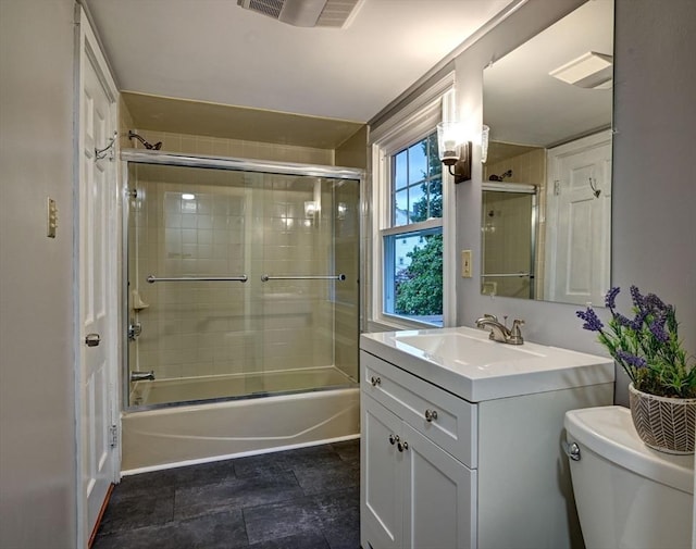 full bathroom with shower / bath combination with glass door, vanity, and toilet