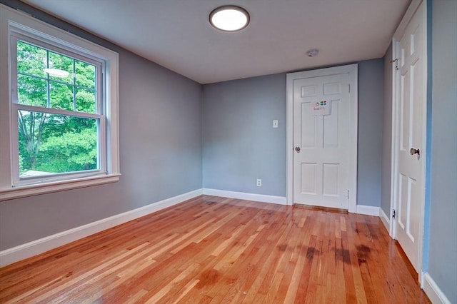 spare room with light wood-type flooring