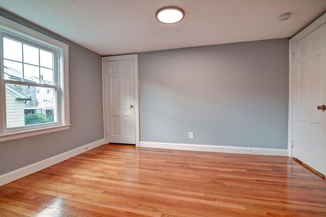 spare room with a healthy amount of sunlight and light hardwood / wood-style floors