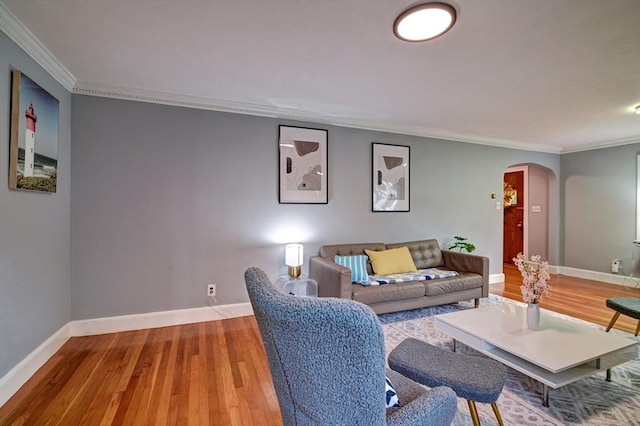 living room featuring hardwood / wood-style flooring and ornamental molding