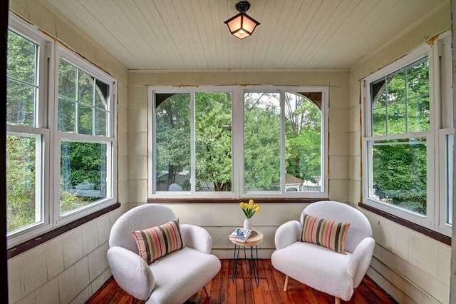 sunroom / solarium featuring a wealth of natural light and wooden ceiling