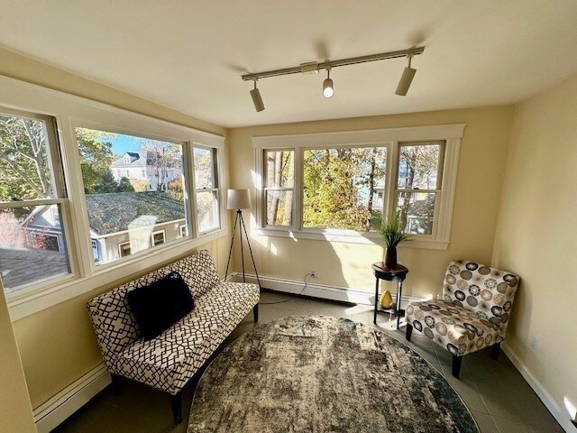 sunroom with baseboard heating and rail lighting