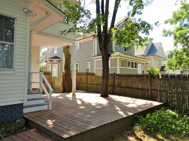 wooden terrace featuring fence