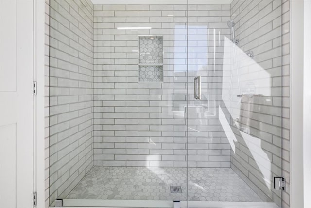 bathroom with a shower with door