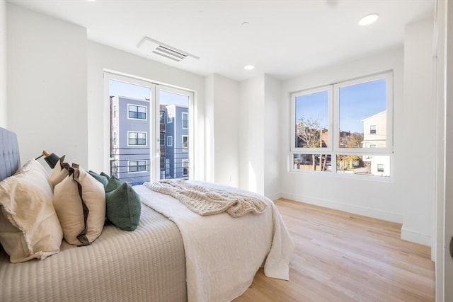 bedroom featuring light hardwood / wood-style floors and access to exterior