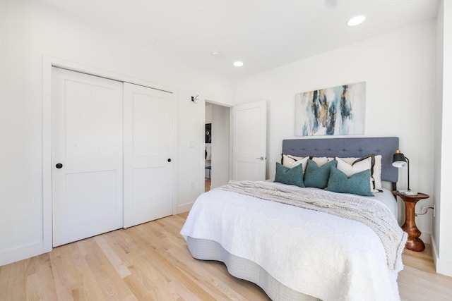 bedroom with hardwood / wood-style flooring and a closet