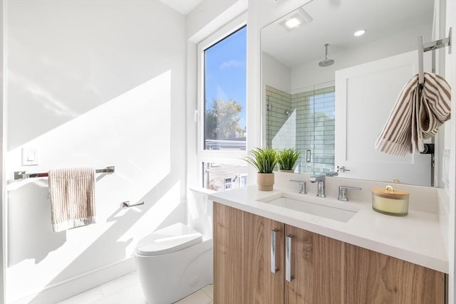 bathroom with tile patterned floors, vanity, toilet, and walk in shower