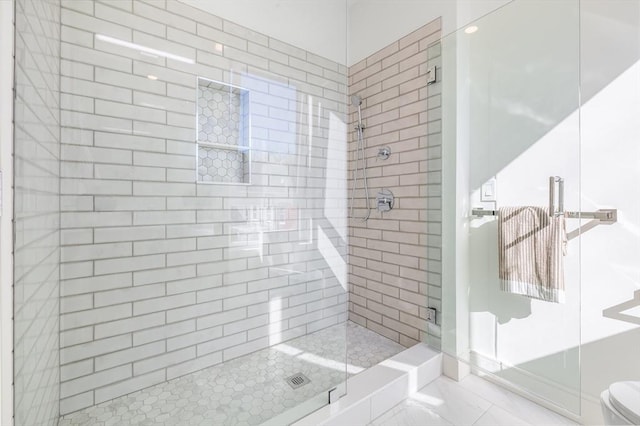 bathroom featuring toilet and an enclosed shower