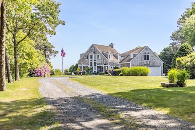 461 Wings Neck Rd, Bourne, MA 02559 - shingle-style home featuring a garage, a front lawn, gravel driveway, and a chimney
