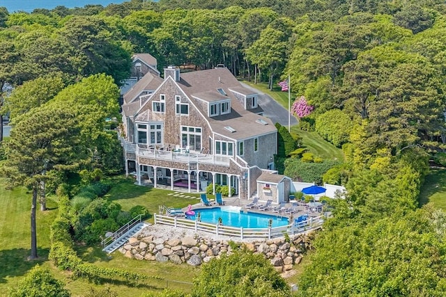 461 Wings Neck Rd, Bourne, MA 02559 - back of house featuring stairs, a forest view, a deck, a fenced backyard, and an outdoor pool