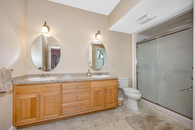 full bathroom with a sink, a shower stall, and toilet
