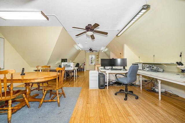 office space with a ceiling fan, vaulted ceiling, and light wood-style floors