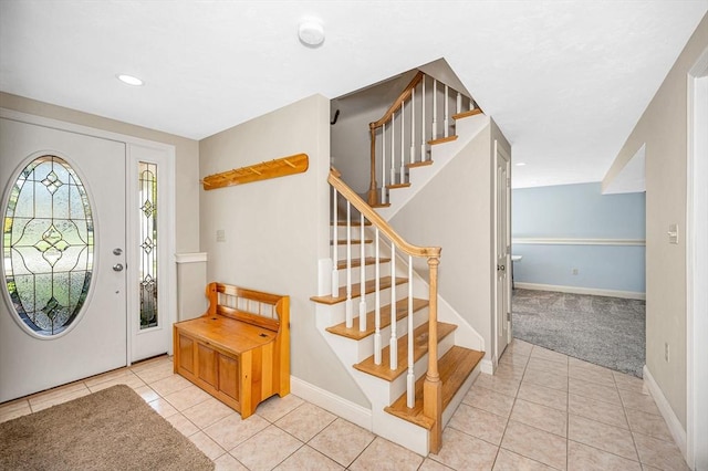 entrance foyer featuring stairway, baseboards, light carpet, recessed lighting, and light tile patterned flooring