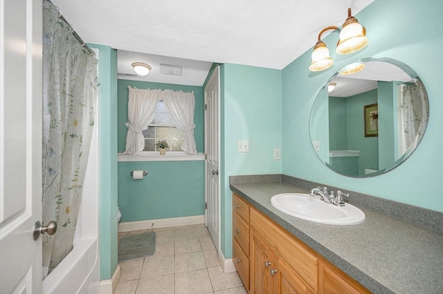 bathroom featuring tile patterned flooring, baseboards, toilet, and vanity