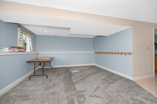 unfurnished room with baseboards and carpet flooring
