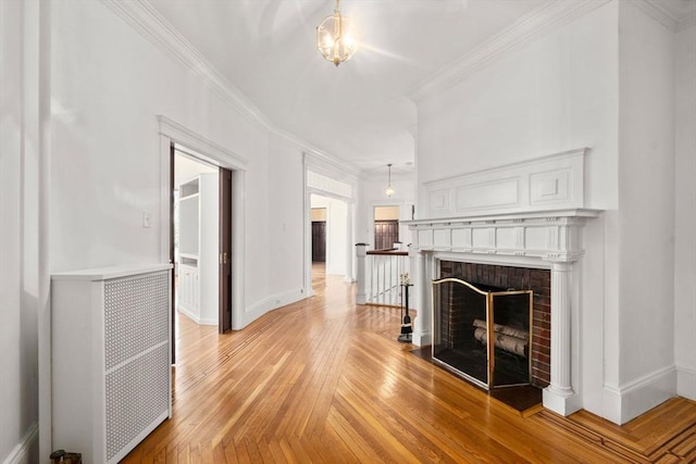 8 Browne St Unit 1, Brookline, MA 02446 - unfurnished living room featuring a fireplace, crown molding, light wood-style flooring, and baseboards