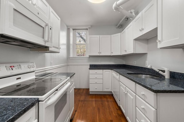 8 Browne St Unit 1, Brookline, MA 02446 - kitchen with a sink, dark stone counters, white cabinets, white appliances, and dark wood-style floors
