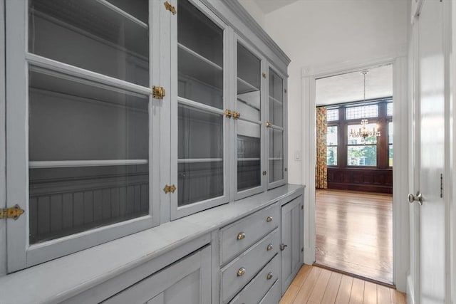8 Browne St Unit 1, Brookline, MA 02446 - interior details featuring wood finished floors and a notable chandelier