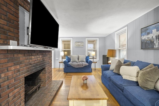 living area featuring a fireplace and wood finished floors