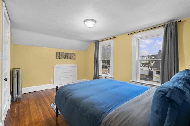 bedroom with lofted ceiling, access to outside, hardwood / wood-style flooring, and baseboards