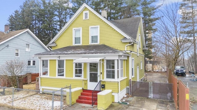 view of front of house with a shingled roof, entry steps, a gate, and fence private yard