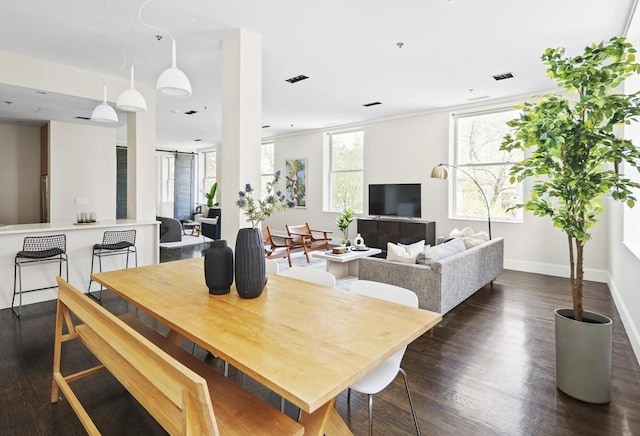 dining area featuring dark wood finished floors, visible vents, and baseboards