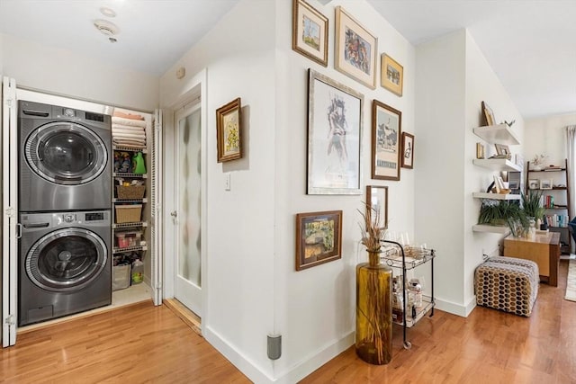 519 Harrison Ave Unit 314, Boston, MA 02118 - laundry area with stacked washer / dryer, wood finished floors, and baseboards