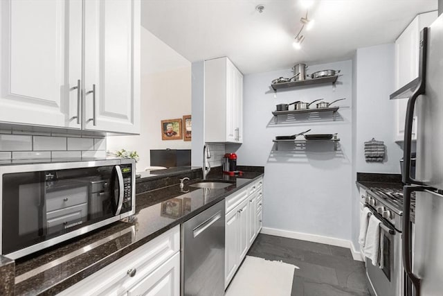 519 Harrison Ave Unit 314, Boston, MA 02118 - kitchen with stainless steel appliances, white cabinets, a sink, open shelves, and dark stone counters