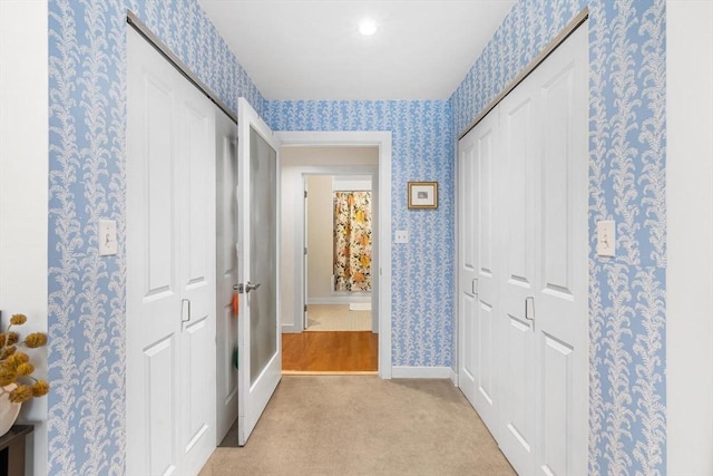 519 Harrison Ave Unit 314, Boston, MA 02118 - hall with wallpapered walls, light carpet, and baseboards