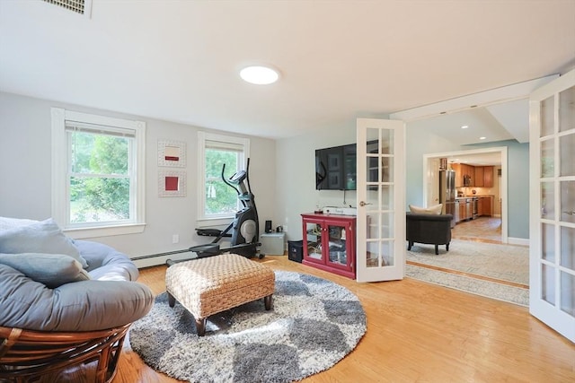 211 Hayden Rowe St, Hopkinton, MA 01748 - living room with french doors and light wood-style flooring