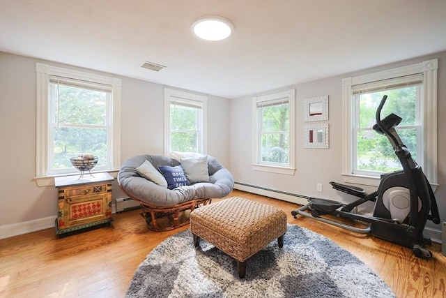 211 Hayden Rowe St, Hopkinton, MA 01748 - living area with wood finished floors and a baseboard heating unit