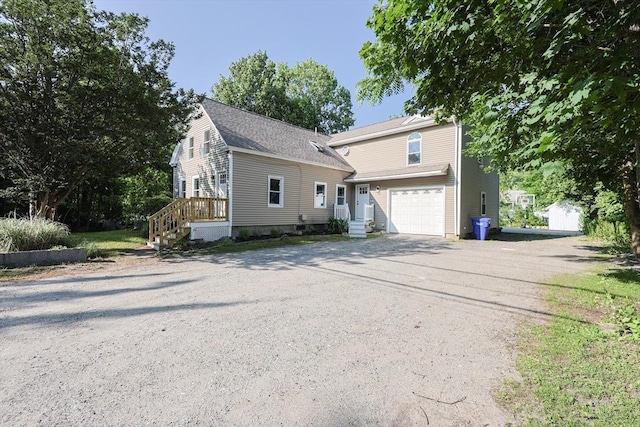 211 Hayden Rowe St, Hopkinton, MA 01748 - view of front of home with driveway and a garage