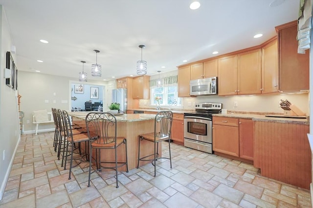 211 Hayden Rowe St, Hopkinton, MA 01748 - kitchen with appliances with stainless steel finishes, a center island, recessed lighting, a kitchen bar, and light stone finish flooring