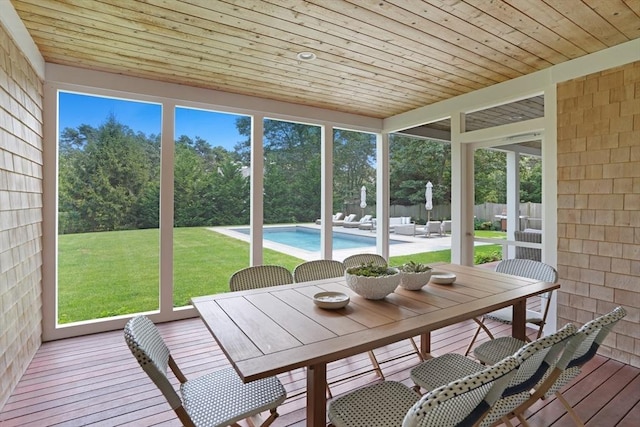 sunroom / solarium with outdoor dining space and plenty of natural light