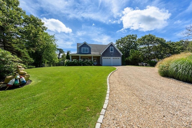 view of front of property with a front lawn, dirt driveway, and a garage