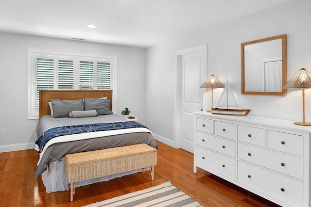 bedroom featuring light wood-type flooring, baseboards, and recessed lighting