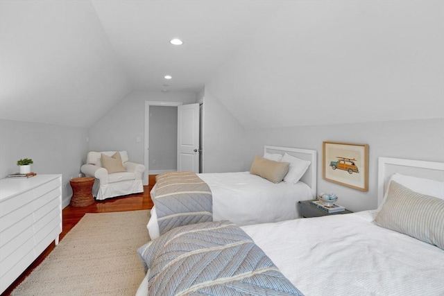bedroom with lofted ceiling, wood finished floors, and recessed lighting