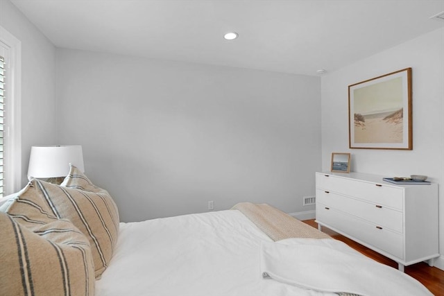 bedroom featuring wood finished floors, recessed lighting, and baseboards
