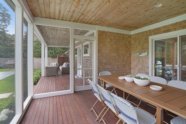 sunroom / solarium with outdoor dining area